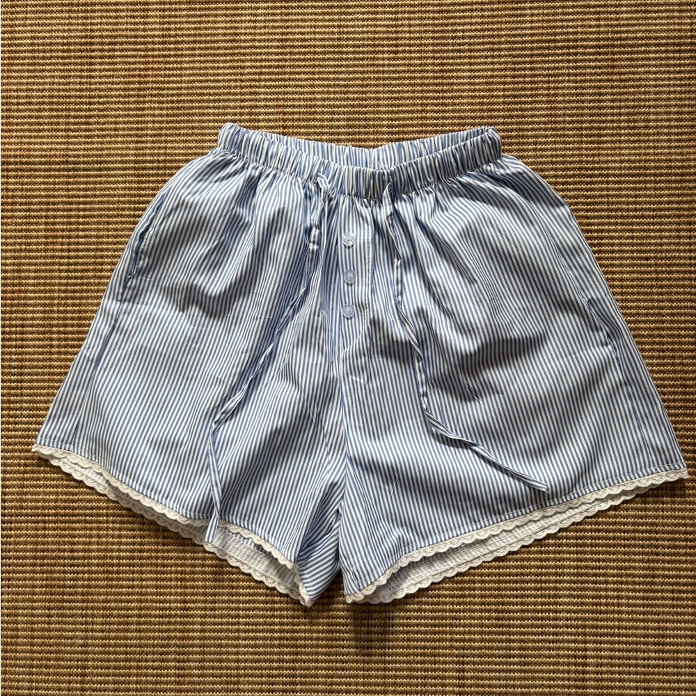 Blue and white striped shorts with white lace hems
